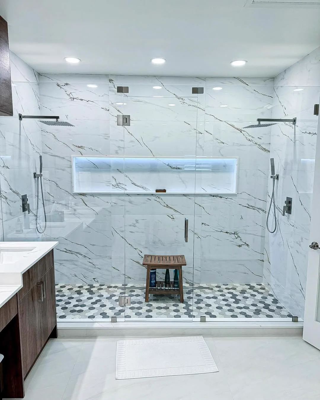 Marble walk-in shower with black fixtures